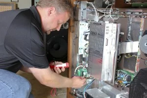 Technician servicing an Allen organ