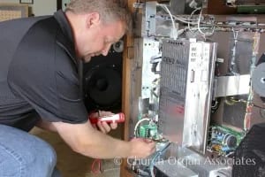 Technician servicing an Allen organ